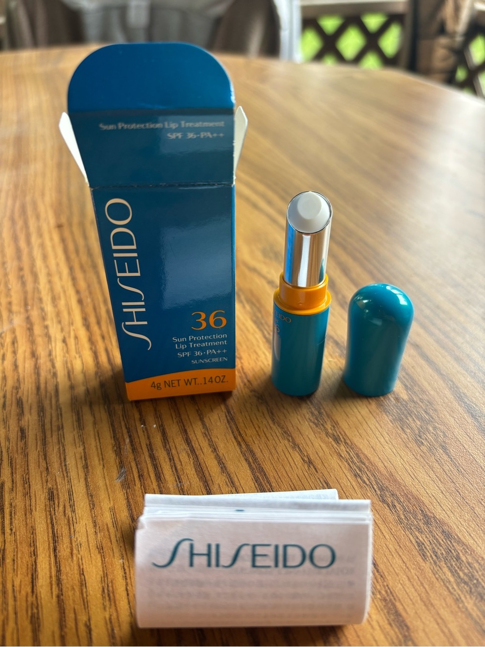 Shiseido Sun Protection Lip Treatment SPF 36 - 14 oz. Teal and Gold